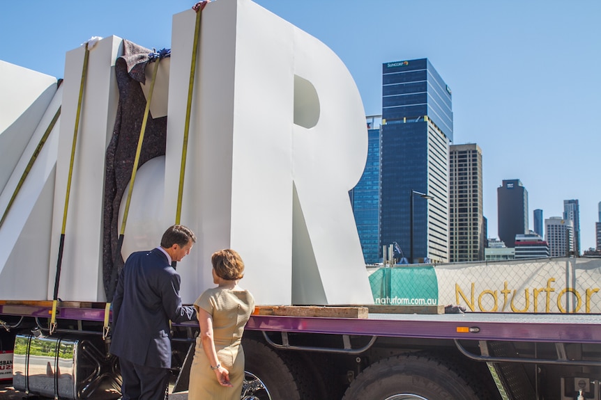 Deputy Premier Jackie Trad and Brisbane Lord Mayor Graham Quirk look at the letters ahead of installation.