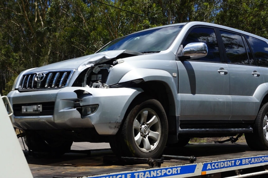 A silver four-wheel drive with damage to the front passenger side