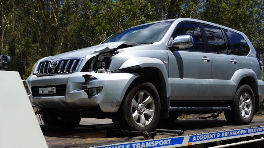 A silver four-wheel drive with damage to the front passenger side
