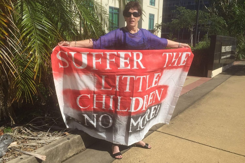 Pat Garnett shows support to the victims of abuse outside Rockhampton court house.