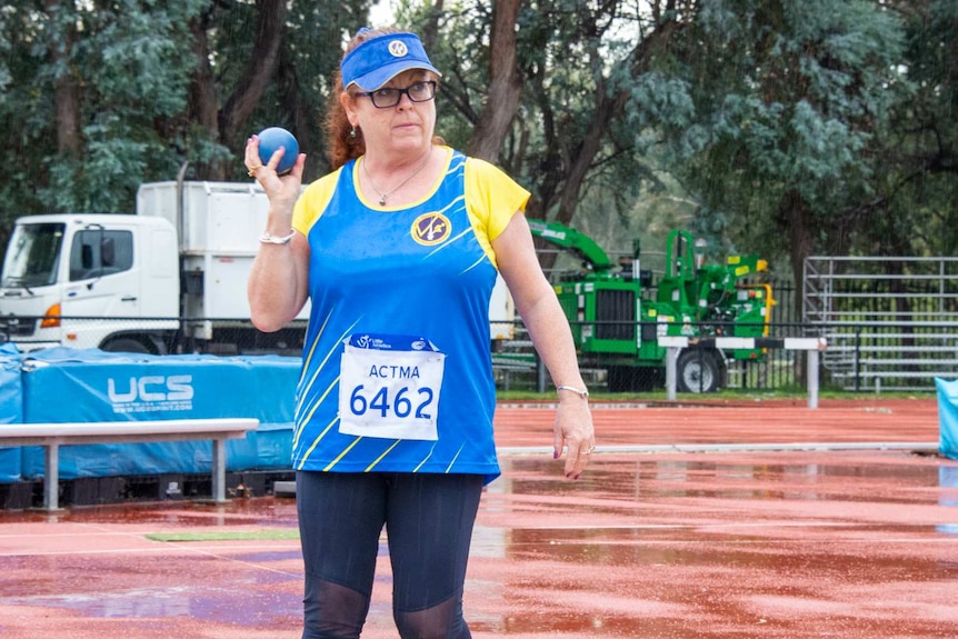 A woman throwing a shot put.