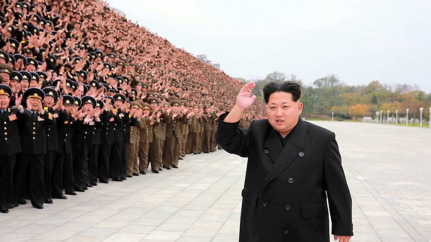 North Korean leader Kim Jong-Un attends a gathering with military officers.