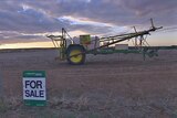 A 'for sale' sign stands outside a farm in the wheatbelt region of Western Australia.