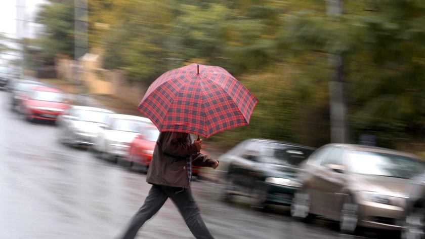 A man hurries through the rain