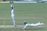 David Warner takes a one-handed diving catch to remove Dimuth Karunaratne.