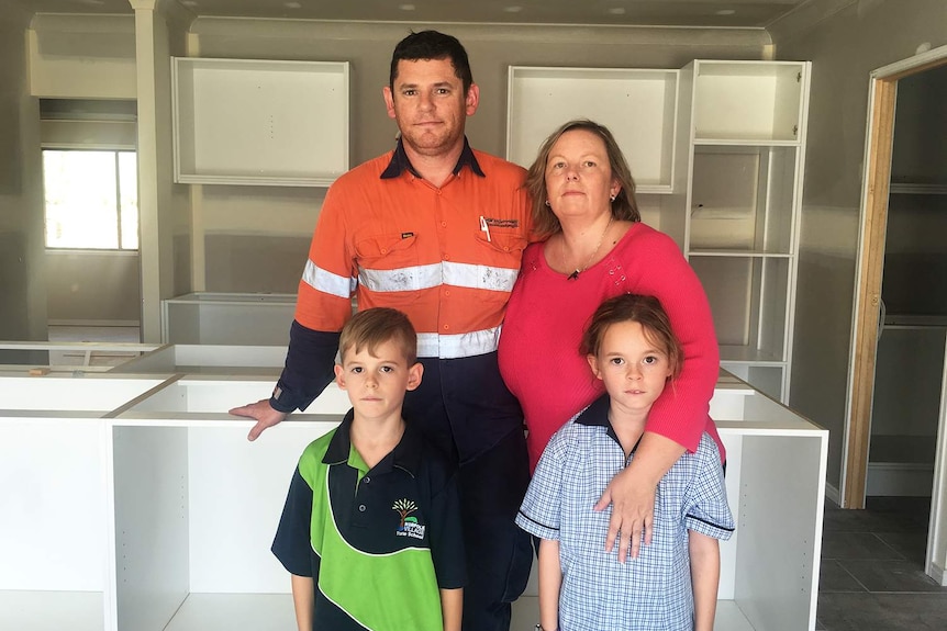 Kristi and Martin Sorrell with their children Marcus and Sasha stand in their unfinished home being built on the Gold Coast.