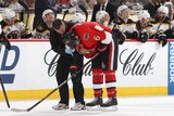 The Ottawa Senators' Bobby Ryan (R) is helped off the ice after getting checked during an NHL game.