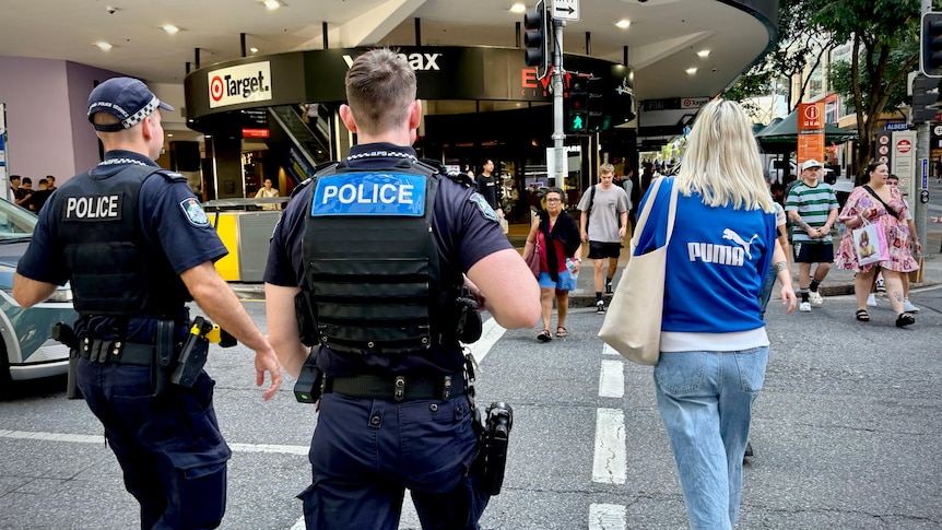 two police officers crossing a Brisbane CBD road