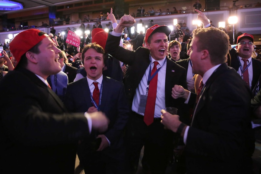 Men in suits cheer as Donald Trump wins Ohio and Florida.