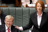 Kevin Rudd receives a pat on the shoulder from Julia Gillard
