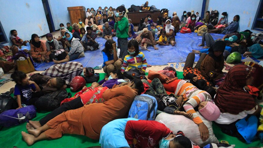 Villagers sleep at temporary shelter