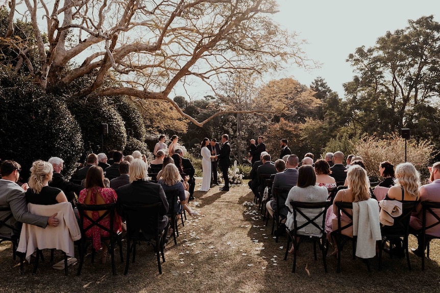 Celebrant Josh Withers presides over a wedding ceremony