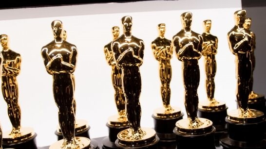 Several Oscar awards standing together.