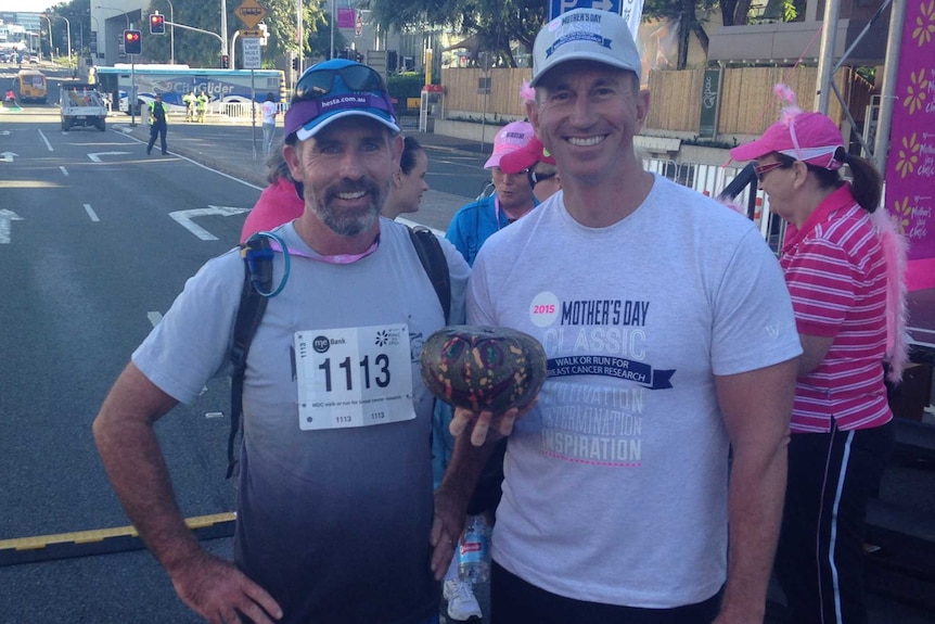 Lismore man Luke Gooley poses with a pumpkin he grew along with Olympian Duncan Armstrong