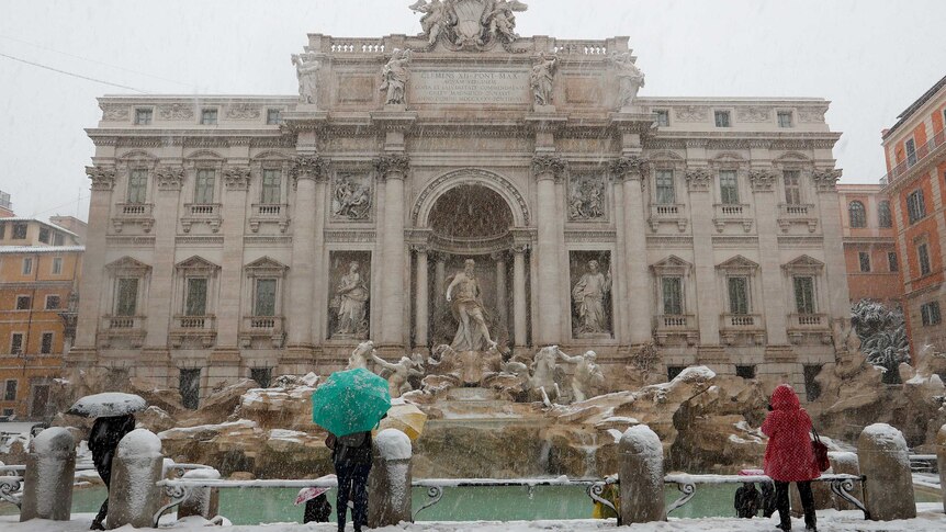 Trevi fountain is covered in snow during a heavy snowfall in Rome.