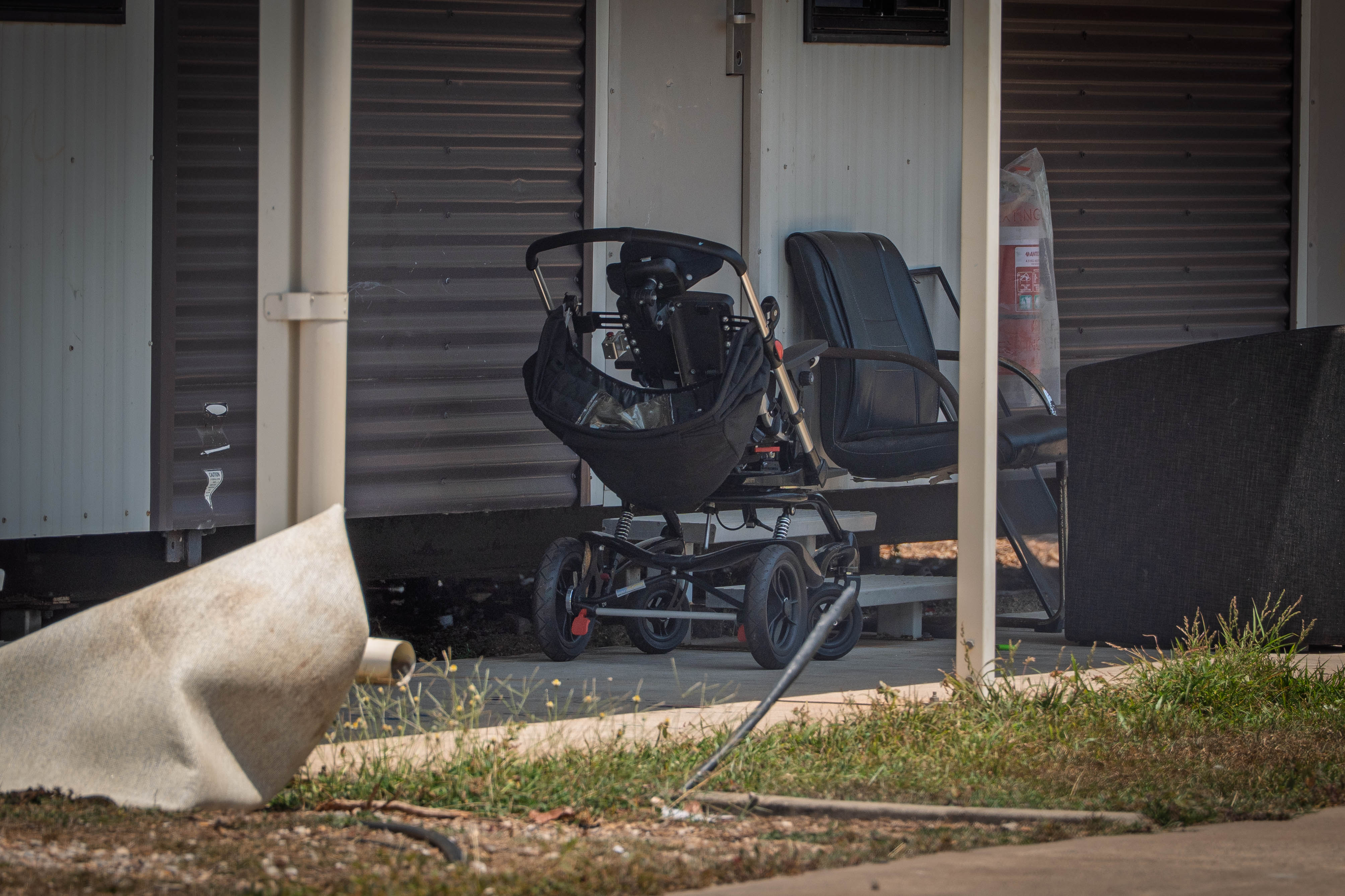 A motorised wheelchair parked outside a home in the YiSSA short-stay centre.