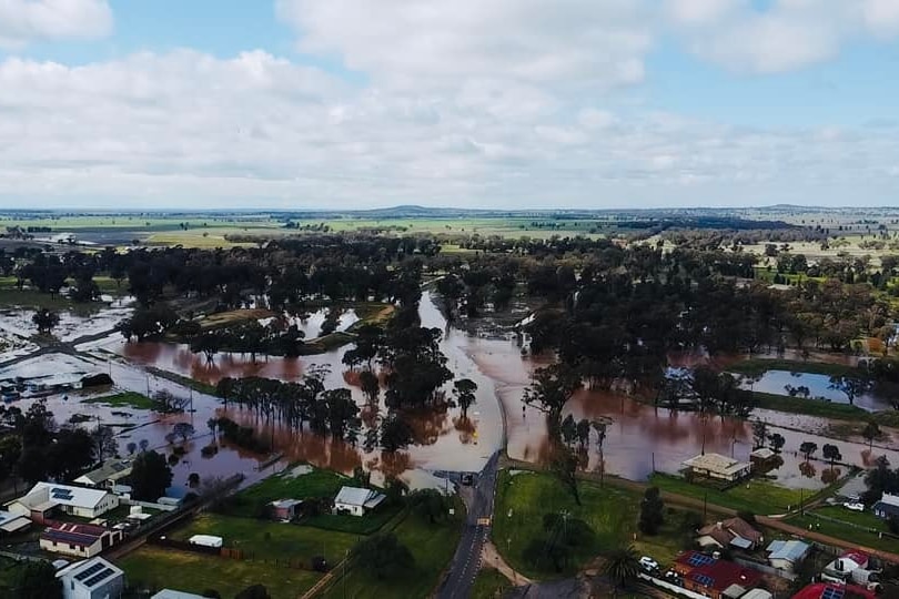 An aerial view of a town with floodwater over the streets.