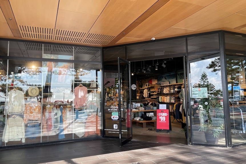 A shop with open doors and a sign out the front.