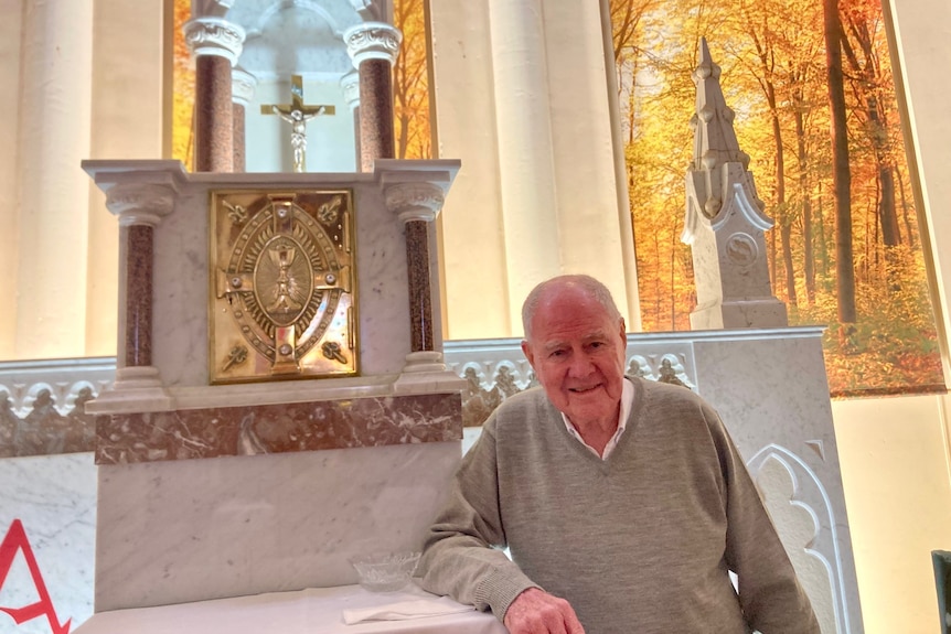 Father Hal Ranger standing next to the alter in the Toowoomba Cathedral. 