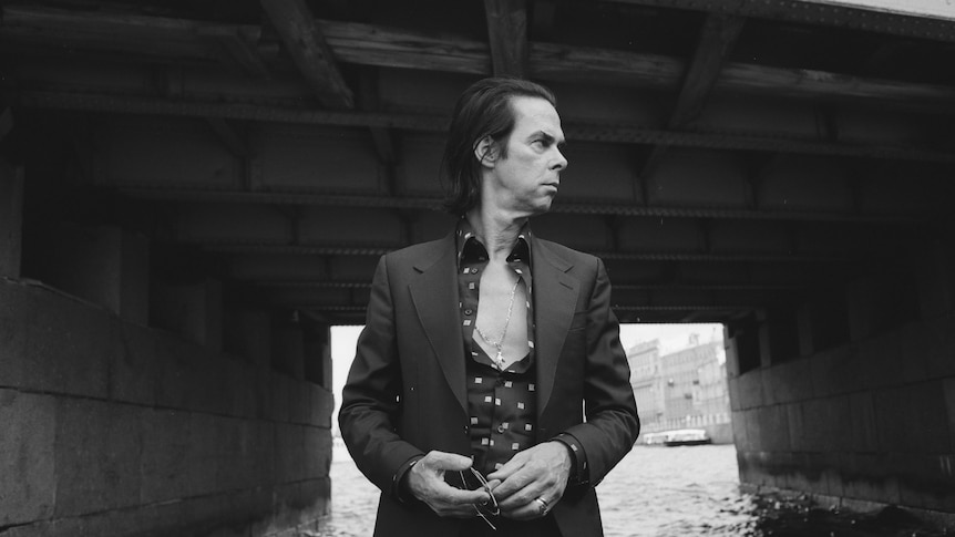 Australian musician Nick Cave looks over his shoulder to his left