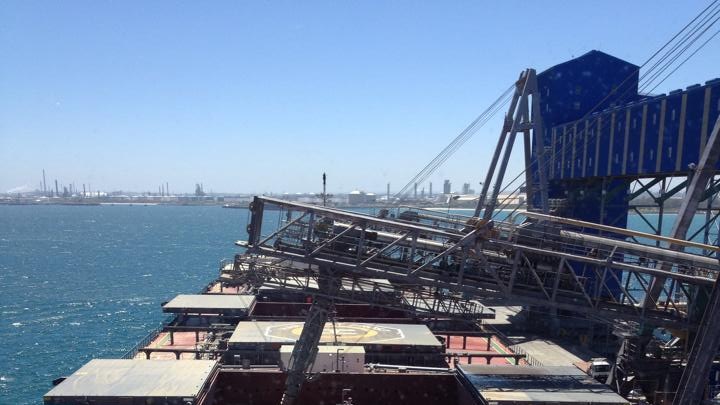 A close-up of a ship docked at the Kwinana port being filled with grain for the export market