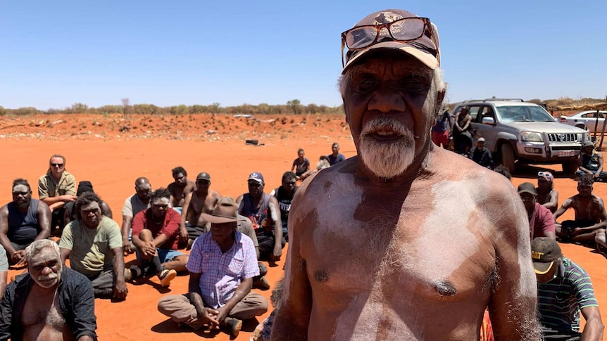 Elder Eddie Robertson looks at the camera at a gathering in Yuendumu.