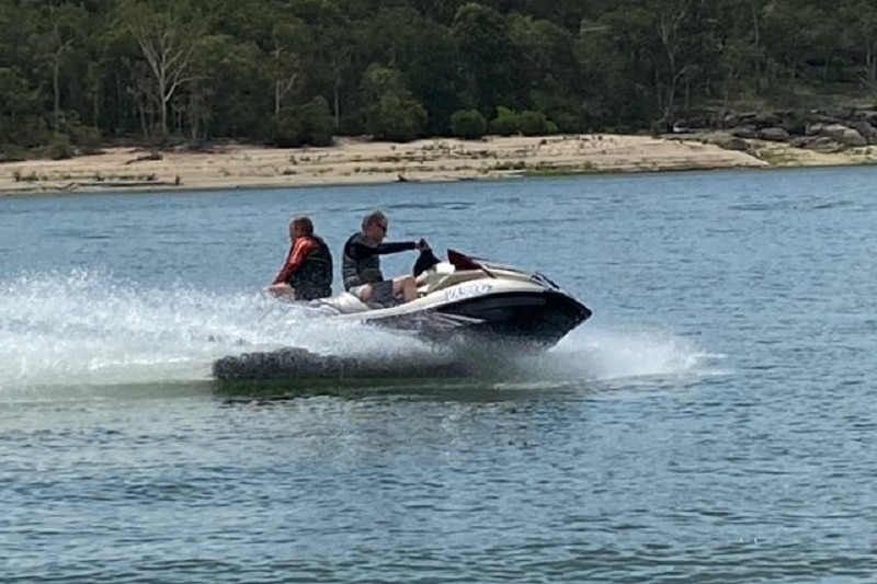 Christian McDonald and another person jet skiing on Lake Tinaroo