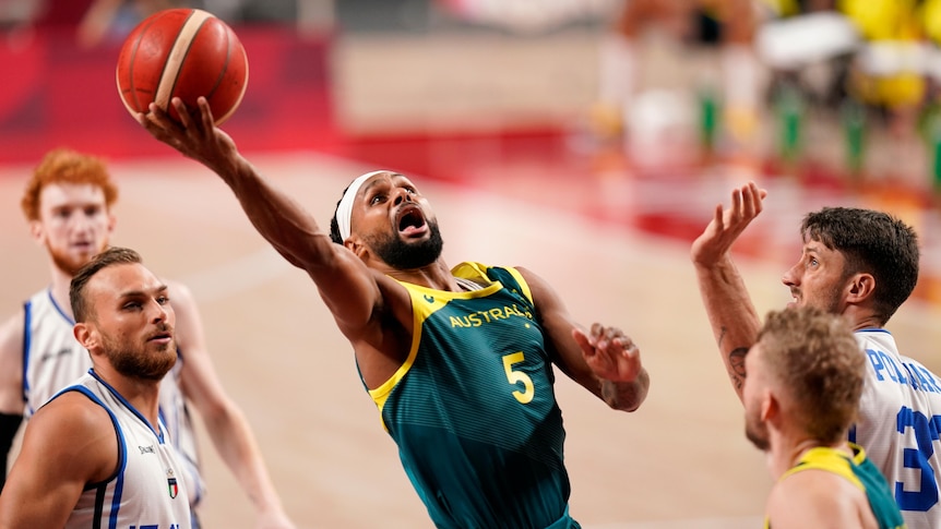 Patty Mills flips up a shot during a group match against Italy at the Tokyo Olympics.