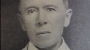 A black and white headshot of a man.