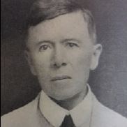 A black and white headshot of a man.