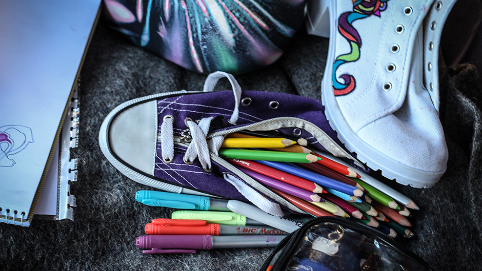 One of Hannah Illingworth's illustrated shoes sits among her art supplies