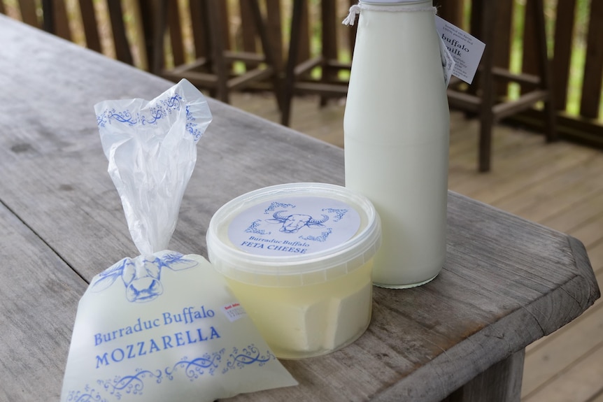 Packaged buffalo mozzarella, feta and milk on a table.