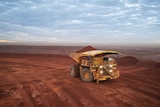 A mining truck carrying iron ore on a remote mine site.
