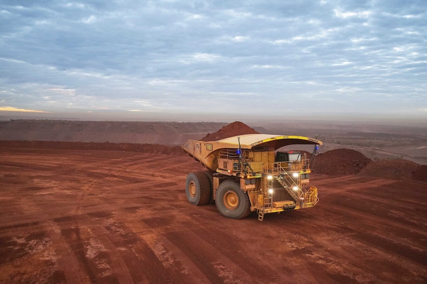 A mining truck carrying iron ore on a remote mine site.