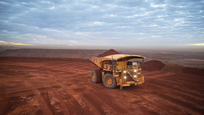 A mining truck carrying iron ore on a remote mine site.