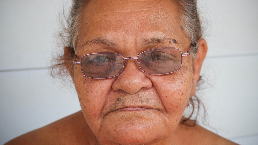 A portrait of Indigenous woman Beryl Charger looking with a serious expression at the camera
