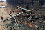 One of almost 1,000 power poles damaged in the South-West fire.