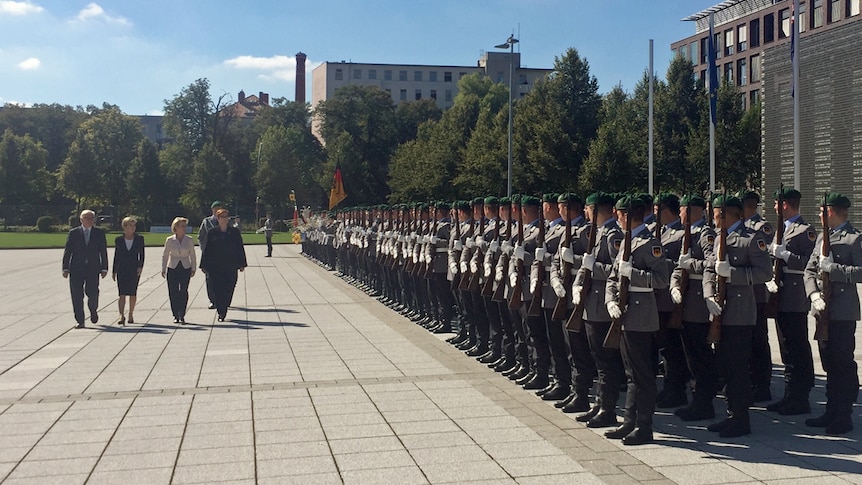 Australia and Germany's foreign and defence ministers walk past a row of troops in Berlin during high-level security meetings.