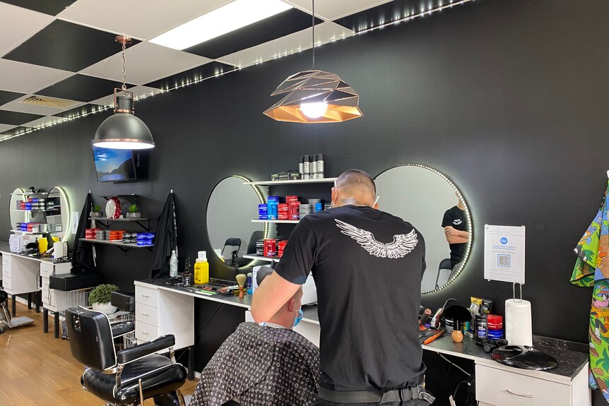 Man cutting hair at barbershop.