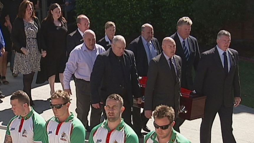 An honour guard farewells rugby league coach Graham Murray at his funeral in Brisbane today.