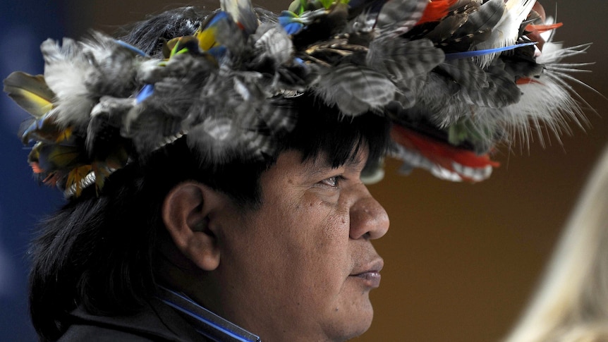 Brazilian Surui tribe chief wears a head dress at the launch of Google site