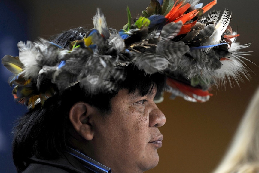 Brazilian Surui tribe chief wears a head dress at the launch of Google site
