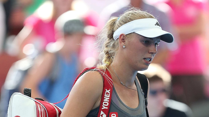 Shock loss ... Caroline Wozniacki leaves the court after losing her match against Ksenia Pervak