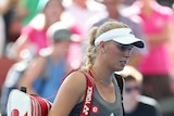 Shock loss ... Caroline Wozniacki leaves the court after losing her match against Ksenia Pervak