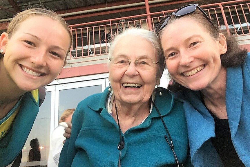 A selfie with a young girl in sports uniform, her granny and mother, all smiling