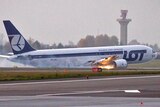 A LOT Polish airlines Boeing 767 slides along the ground after making an emergency landing.