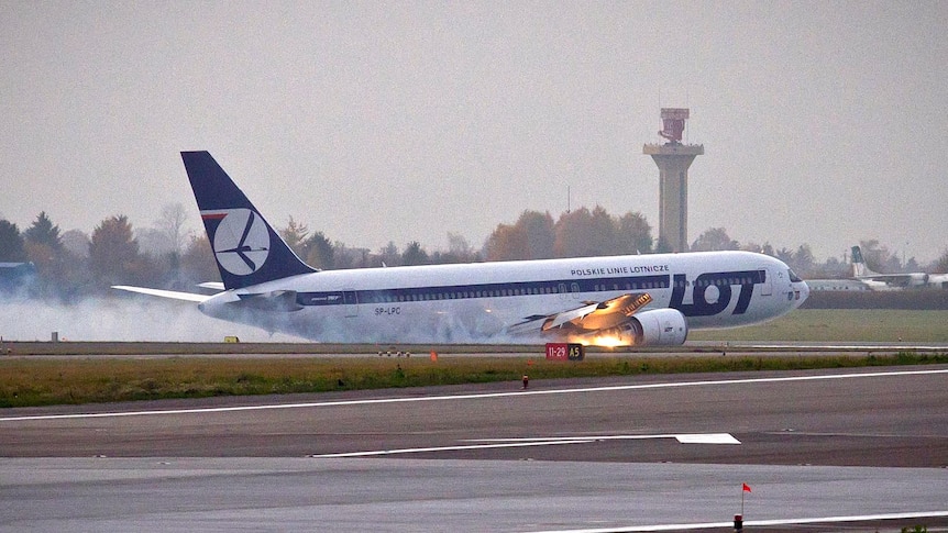 A LOT Polish airlines Boeing 767 slides along the ground after making an emergency landing.