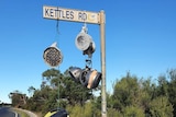 Seven kettles hang on Kettles Road signpost.