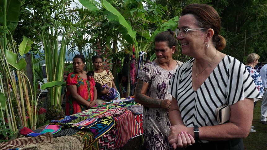 Anne Ruston, Assistant Minister for the Pacific, smiling at women in the PNG highlands.