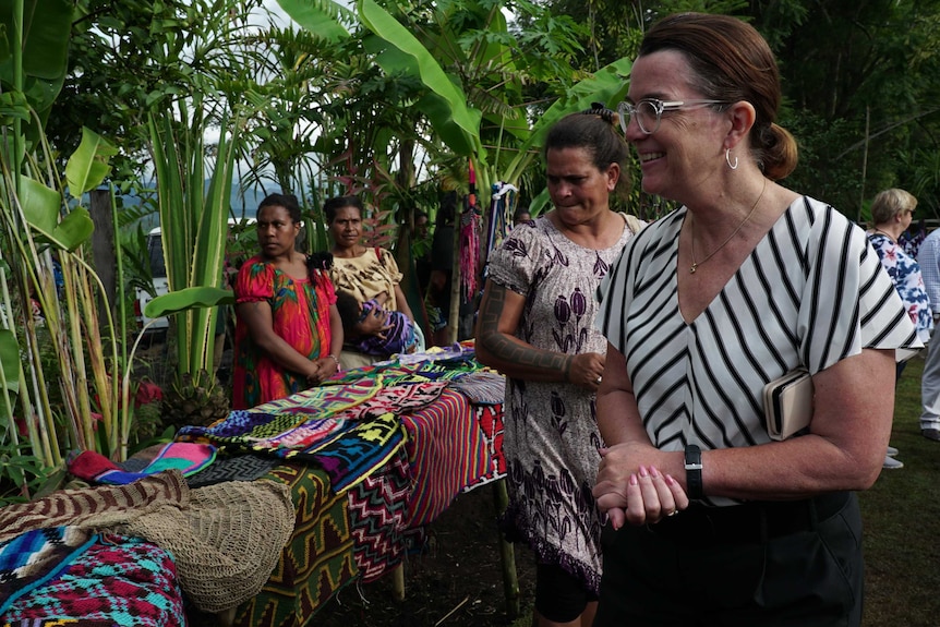 Anne Ruston, Assistant Minister for the Pacific, smiling at women in the PNG highlands.